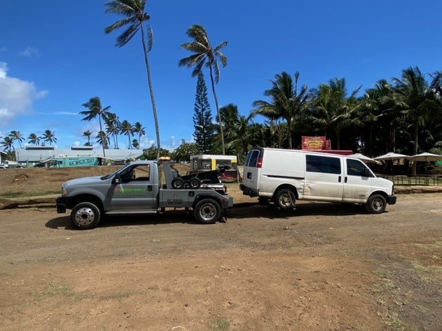 Car being towed by a tow truck near Honolulu.