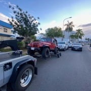 Quikhooks wrecker service, Oahu HI. Image of a jeep being towed by a Honolulu Tow Truck.